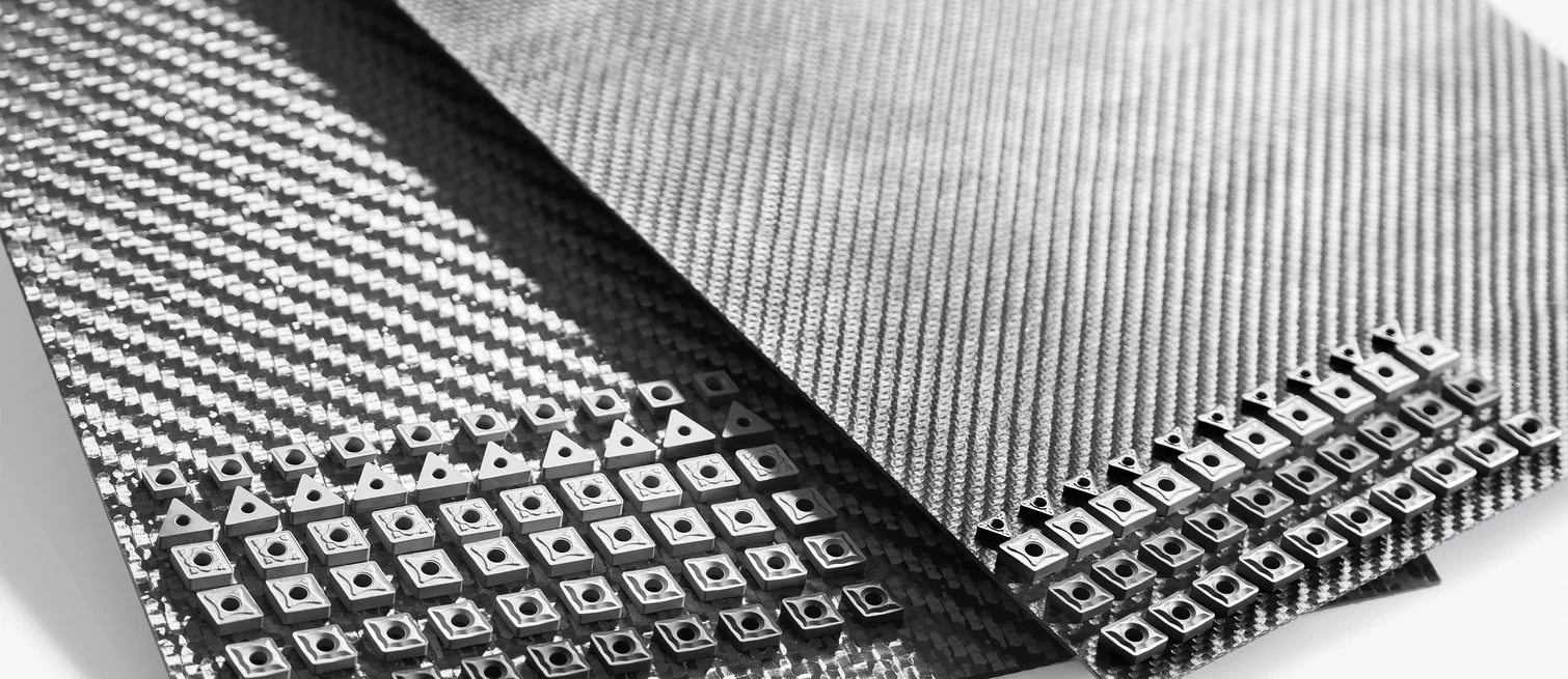  Two CFC plates with characteristic carbon weave structure used as carriers for numerous small indexable inserts or ceramic tool components.