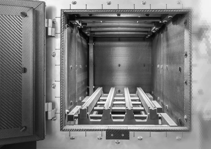  Open high-temperature furnace with heat shields and CFC loading fixture for industrial thermal processing applications.