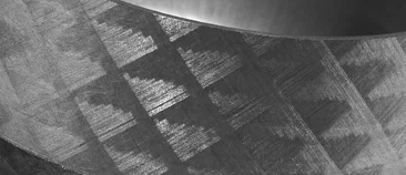  Macro shot of a ground or laminated surface with technical texture, likely made of graphite or composite material.