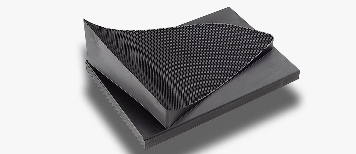 Material sheet with fine honeycomb surface structure, likely made of graphite or fiber-reinforced composite for industrial applications.