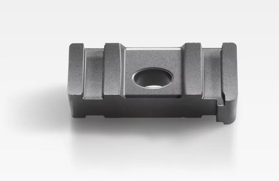  Metal slide for valve control with a central hole and precise contours, shown against a white background