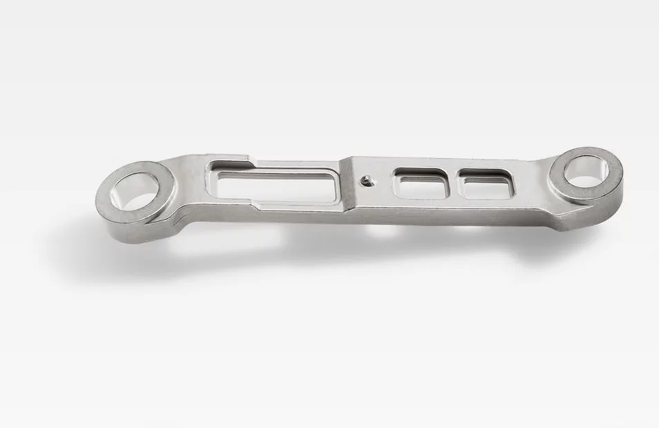  Metal connecting rod for turbochargers with precise cutouts and mounting holes, shown against a white background