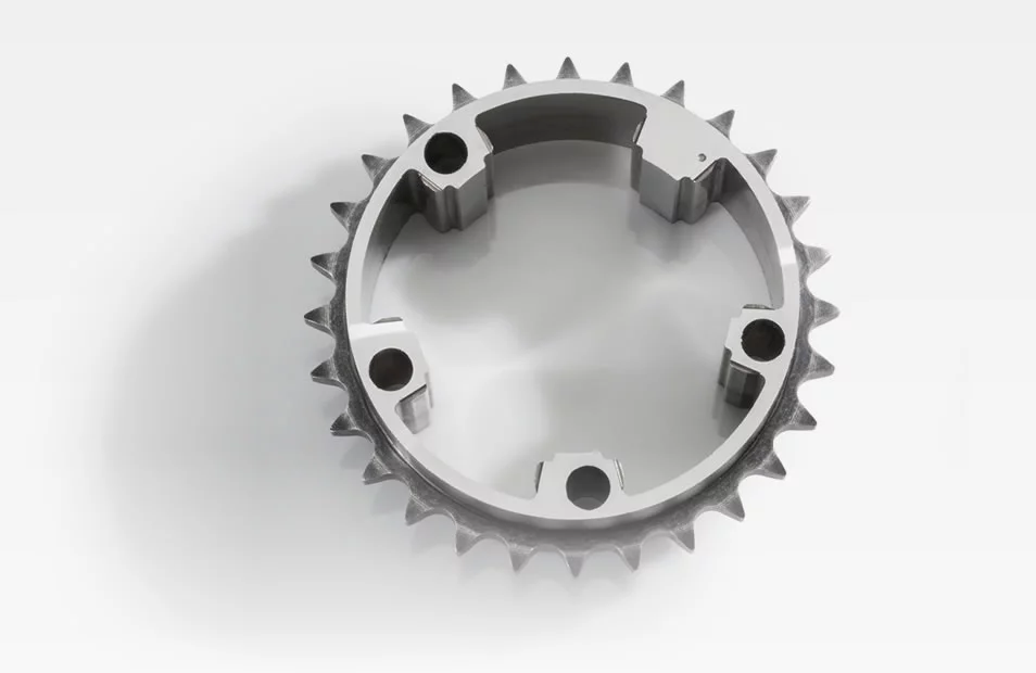  Metal stator sprocket with inner mounting points and outer teeth, shown against a white background