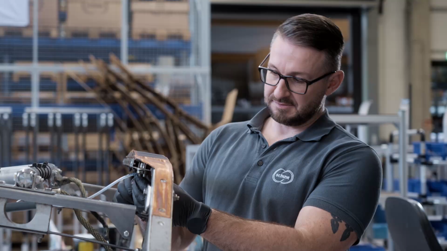  Service employee from Schunk Transit Systems inspecting a contact strip