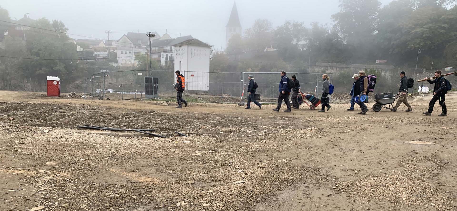  Team of helpers in front of construction fences