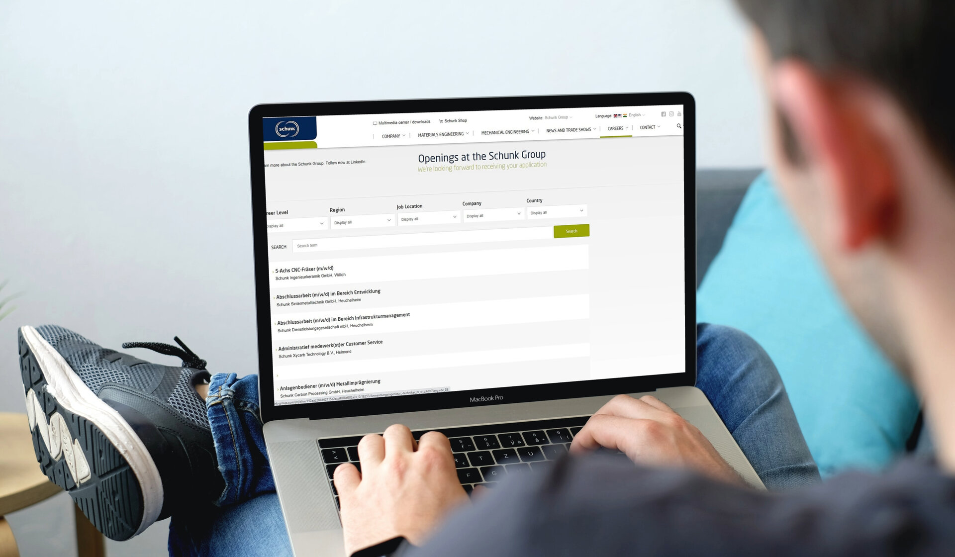  Person sitting at laptop looking at vacancies within the Schunk Group