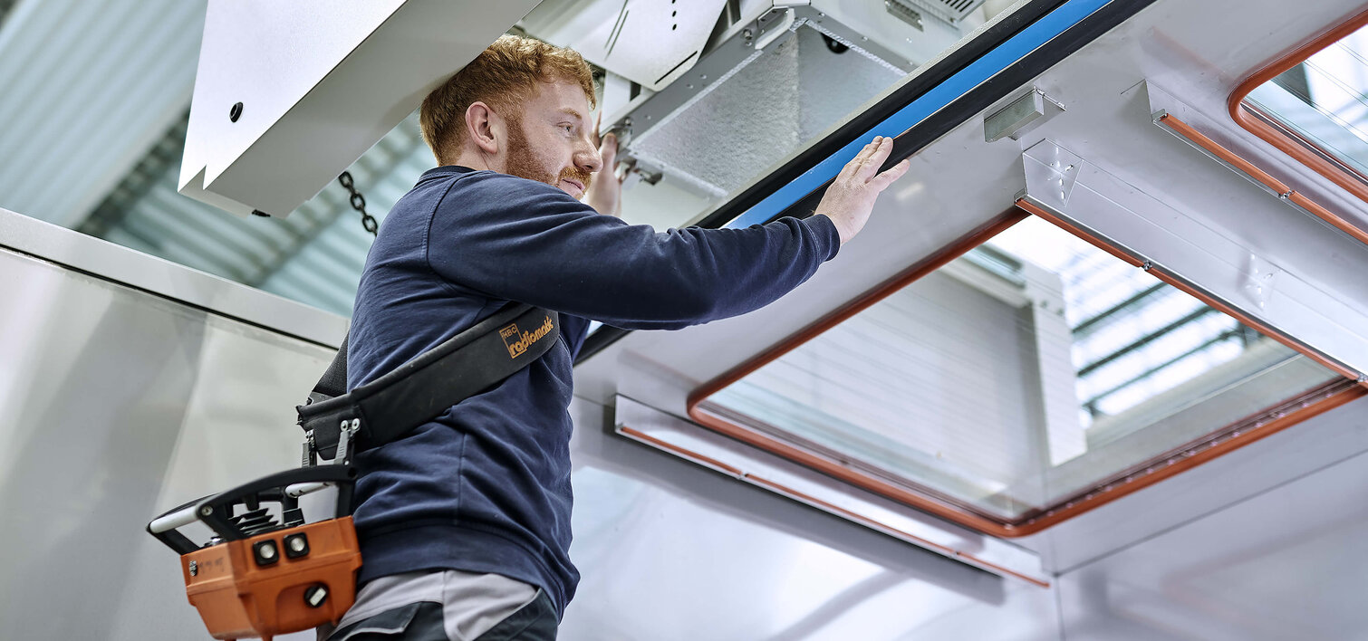 Two Pulsar Photonics employees operate a machine