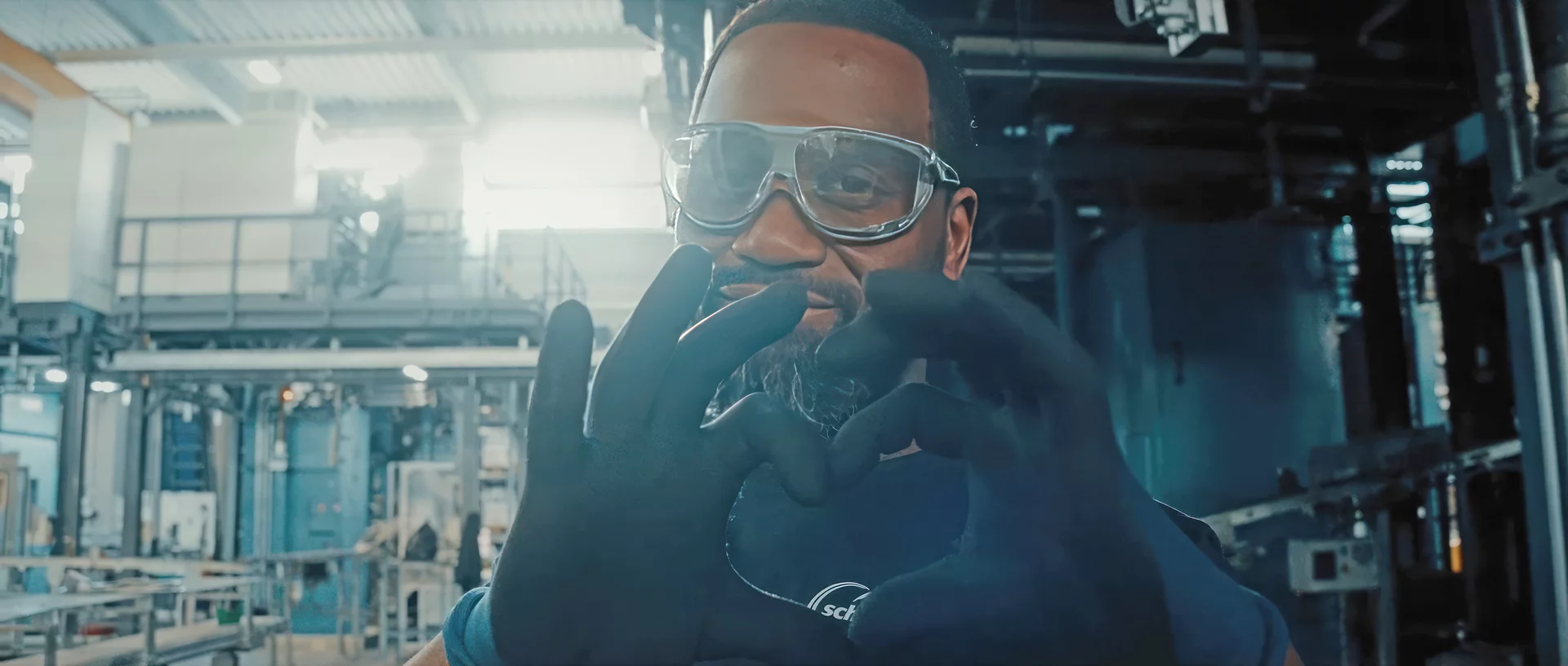  Schunk production employee forming a heart with his hands