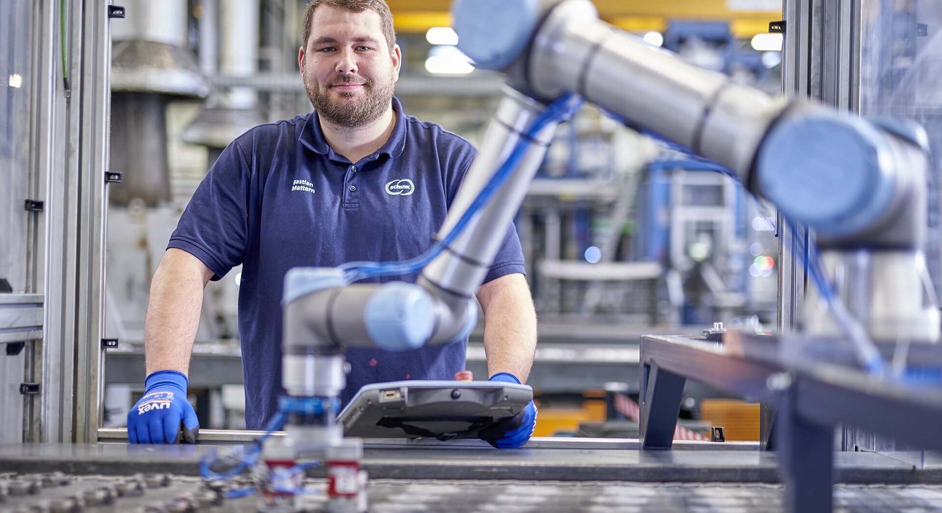  Machine operator at the Schunk Group operates a machine in production